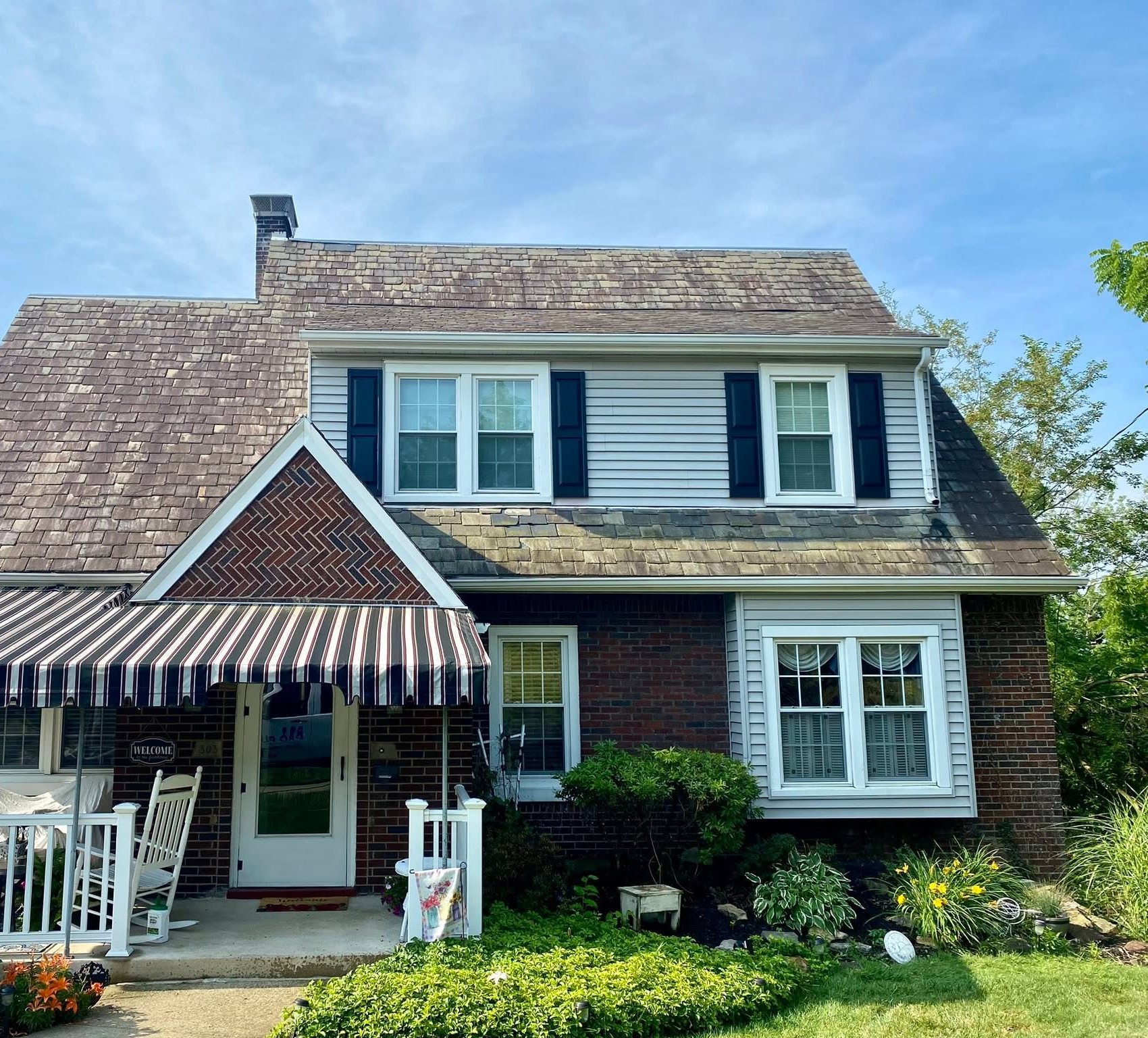 Brick home before Pro Plus soft wash, stained roof and siding